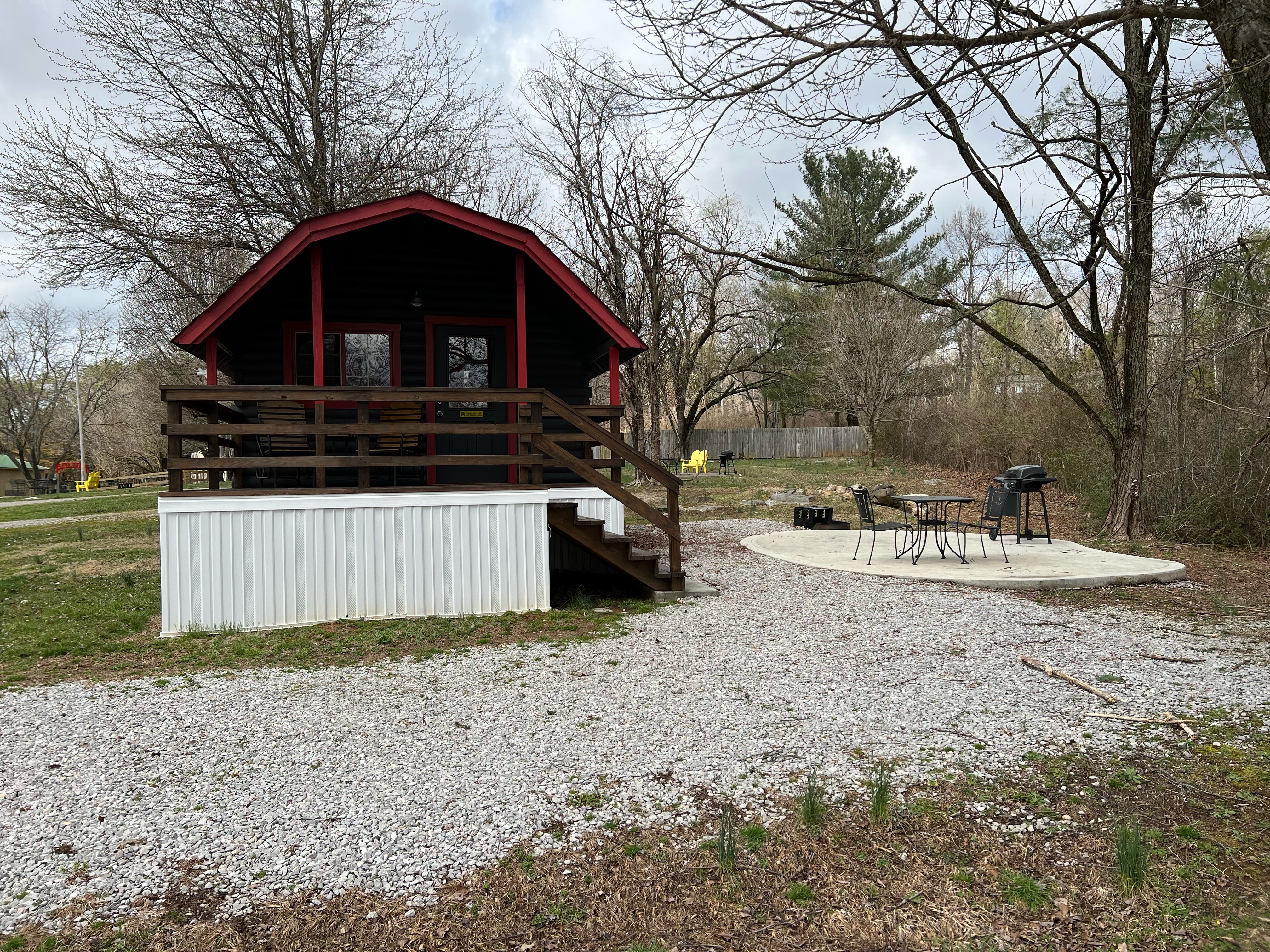 Camping Cabin (full bath with shower), Patio including a mini fridge, coffee pot, gas grill, fire ring, patio set, and glider set