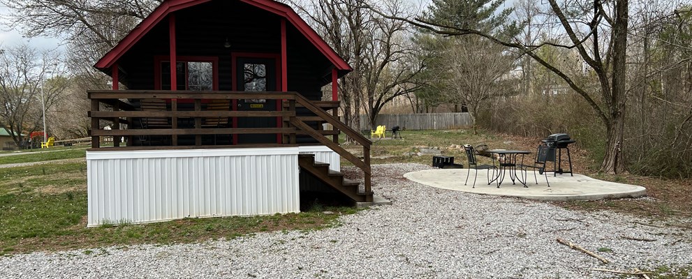 Camping Cabin (full bath with shower), Patio including a mini fridge, coffee pot, gas grill, fire ring, patio set, and glider set