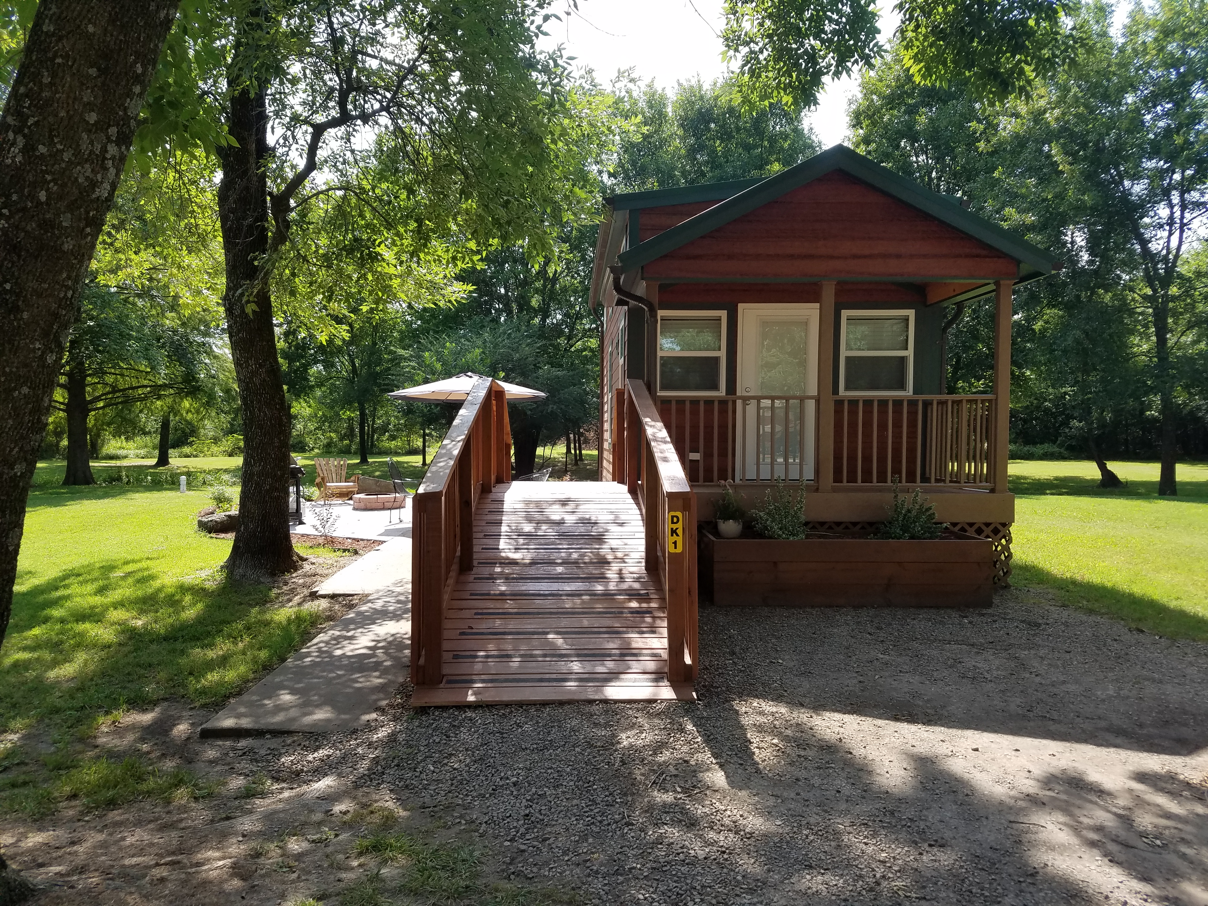 Covered front porch and ramp are just a few of the amenities with our deluxe cabin!