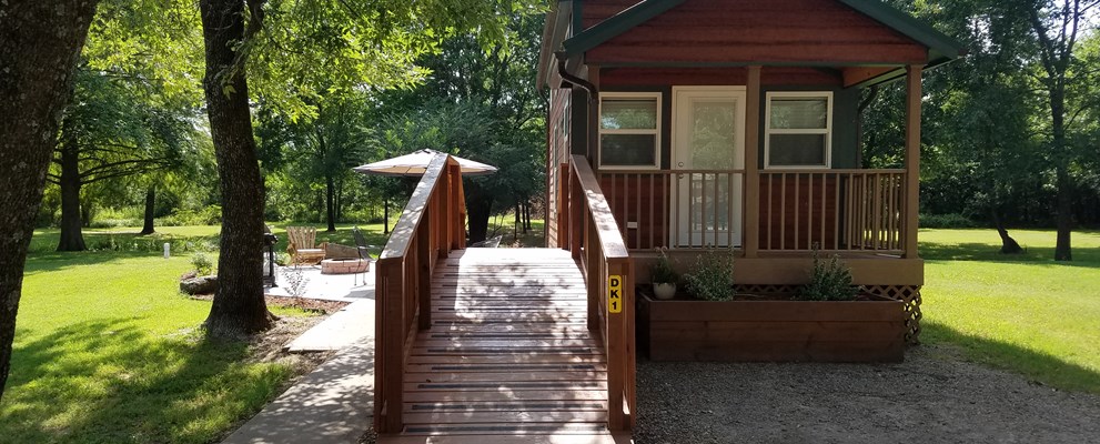 Covered front porch and ramp are just a few of the amenities with our deluxe cabin!