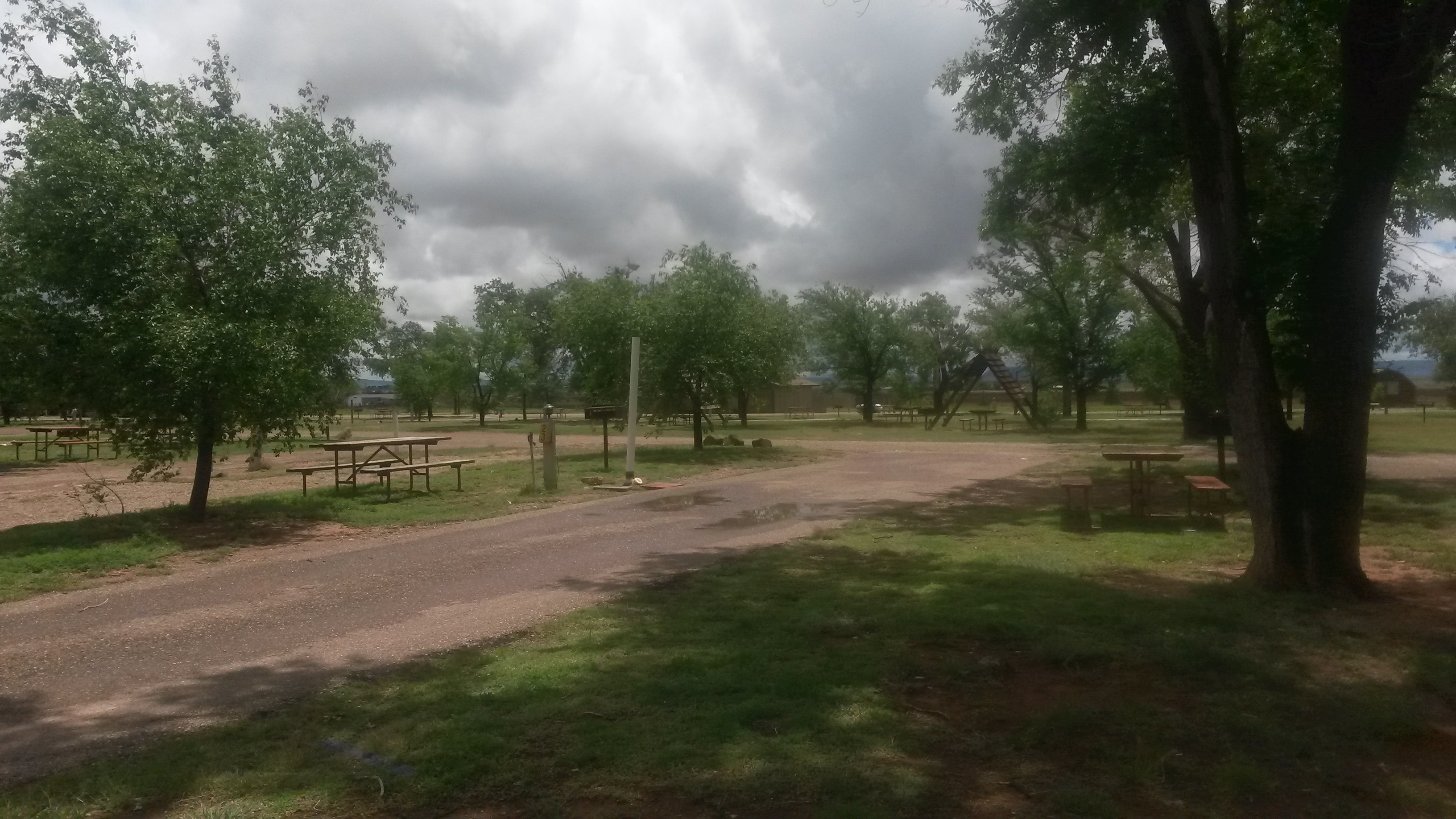 Rare cloudy day for our asphalt end site, Large long pull-thru 30 or 50 amp full service easy in and out, Limited number of these sites they are not together