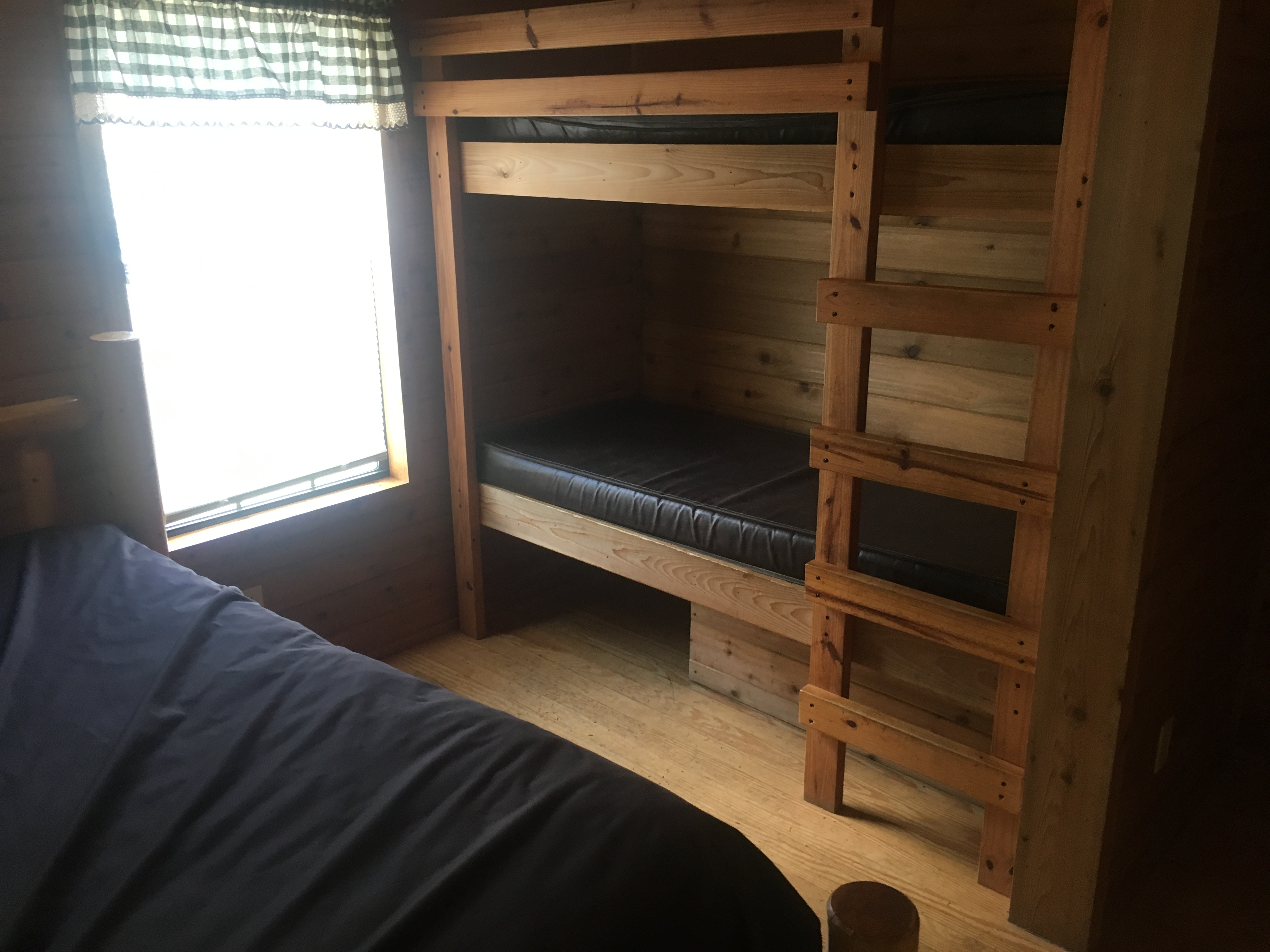 Bedroom area includes full bed and bunk beds