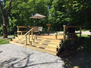 Site DP1 Deluxe Pull thru full Hookup, with table and chair and propane Grill. (Propane for grill is on the house) Large fire pit.