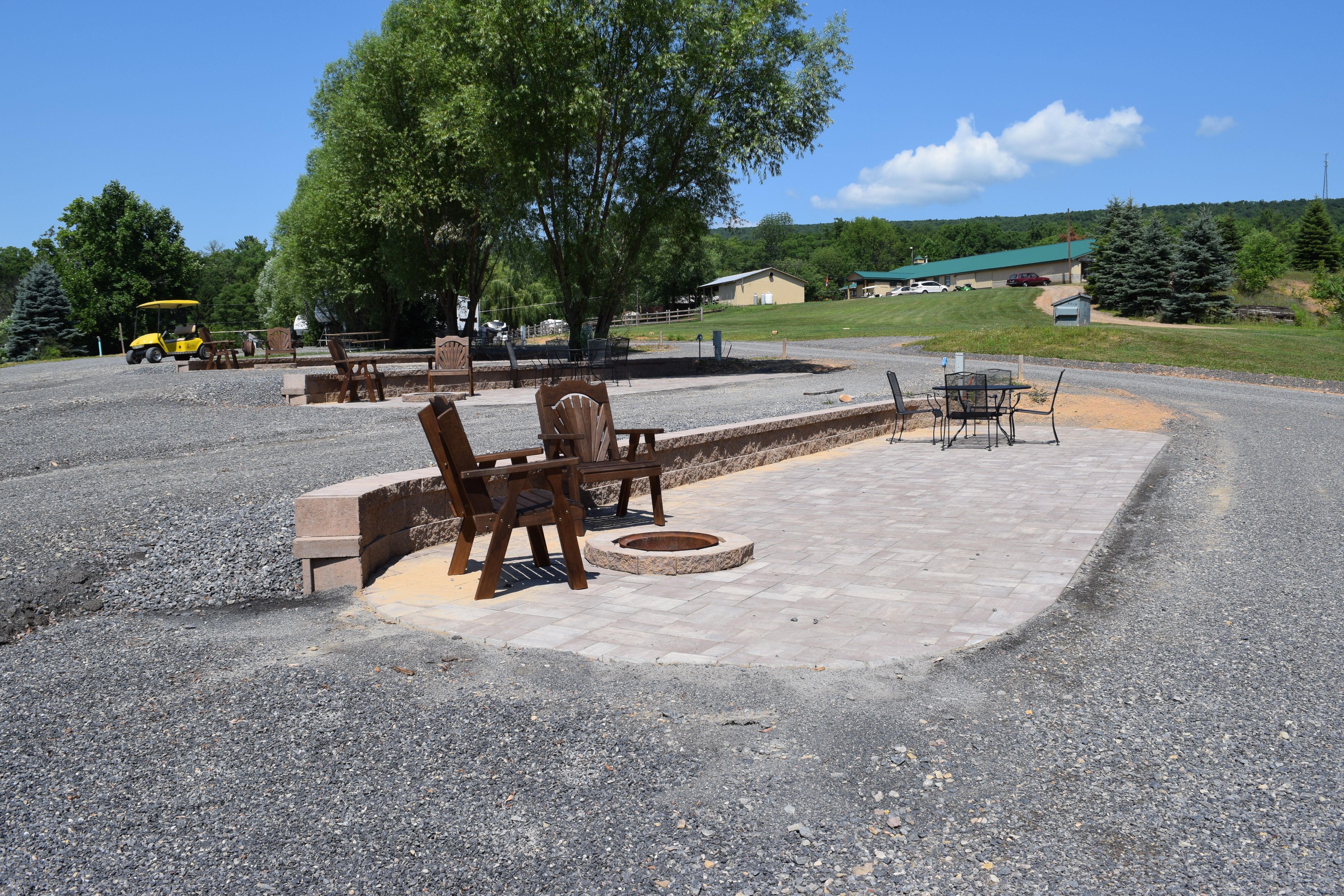Deluxe Patio Pull Thru Site. Spacious site combined with a beautiful  patio, fire pit and outdoor furniture make for a great outdoor experience. 50/30amp elec. Non wooded.