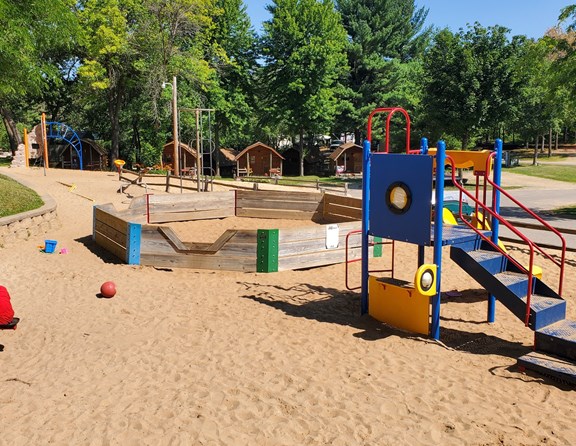 We have a large sandy area with tons of kid structures and play space!