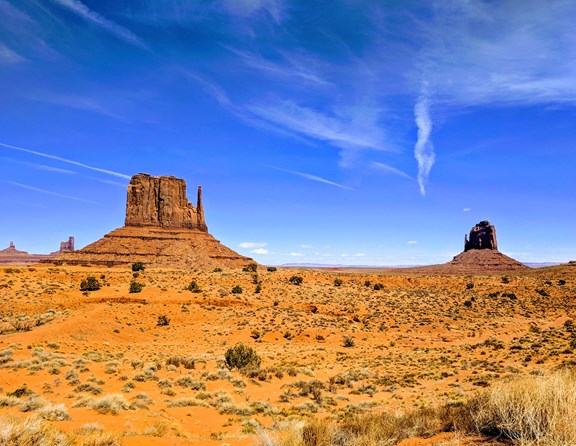 Straddling the Utah-Arizona border is the remarkable Monument Valley Navajo Tribal Park. You may have seen the unique mitten-shaped butte formations on a Western movie but there is nothing quite as amazing as seeing the formations up close looming in front of you! This region is comprised of a rich, red sandy landscape dotted with rock formations protruding up from the ground, carved by years of erosion into unique shapes and groupings. The area is a great place to visit and experience fantastic photo opportunities and stunning scenery. With so much to see and do in the area, many visitors look for camping opportunities nearby and the Monument Valley KOA campground is just a few short miles from the entrance to the park. Tent and RV campers will find a great base to set up for an overnight visit or a longer stay while venturing into the surrounding areas of Utah and Arizona.