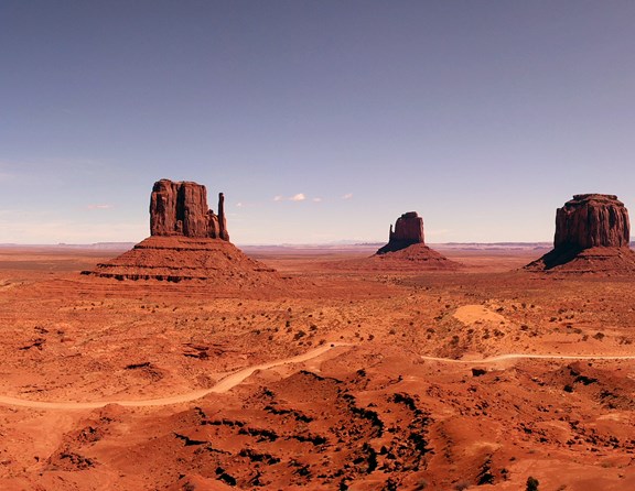 Straddling the Utah-Arizona border is the remarkable Monument Valley Navajo Tribal Park. You may have seen the unique mitten-shaped butte formations on a Western movie but there is nothing quite as amazing as seeing the formations up close looming in front of you! This region is comprised of a rich, red sandy landscape dotted with rock formations protruding up from the ground, carved by years of erosion into unique shapes and groupings. The area is a great place to visit and experience fantastic photo opportunities and stunning scenery. With so much to see and do in the area, many visitors look for camping opportunities nearby and the Monument Valley KOA campground is just a few short miles from the entrance to the park. Tent and RV campers will find a great base to set up for an overnight visit or a longer stay while venturing into the surrounding areas of Utah and Arizona.